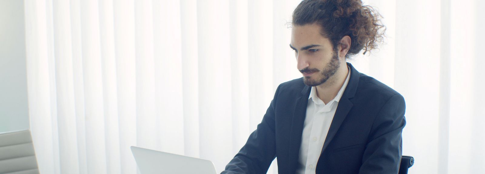 male sitting on laptop
